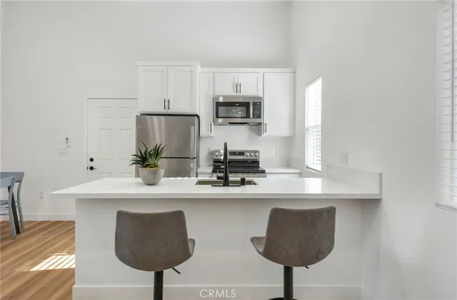 a kitchen with a refrigerator and a table