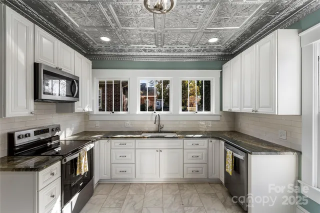a kitchen with a stove top oven a sink and dishwasher