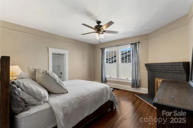 a bedroom with a bed and a fireplace