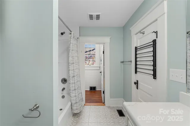 a bathroom with a shower and a sink