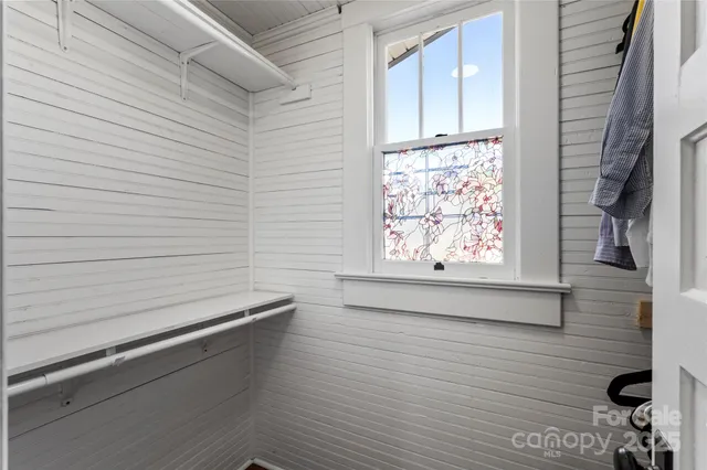 a bathroom with a window and a shower