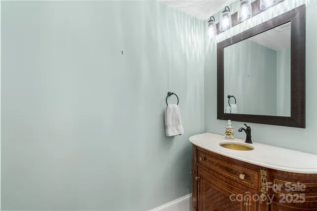 a bathroom with a sink vanity and a mirror