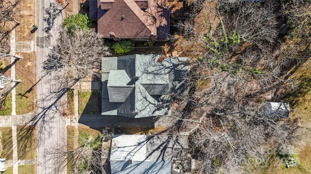 a view of house with a yard and sitting area
