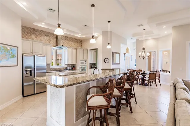 a large kitchen with a table and chairs