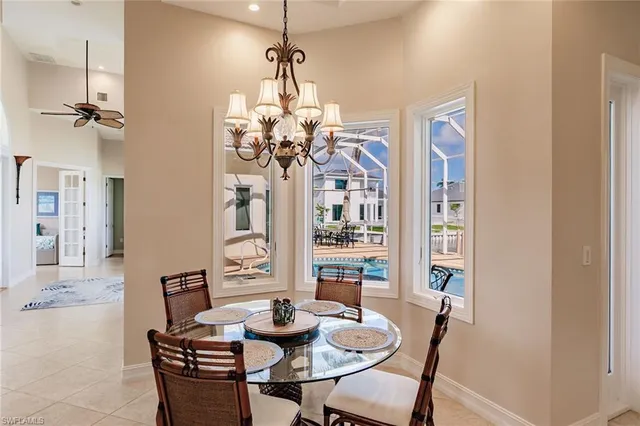 a view of a dining room with furniture a chandelier and wooden floor