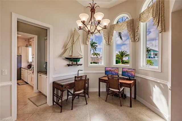 a view of a dining room with furniture and a chandelier