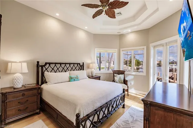 a bedroom with a large bed and a chandelier