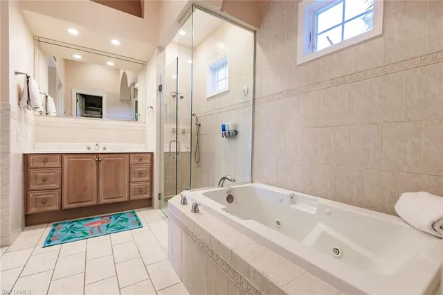 a bathroom with a tub a sink and a shower