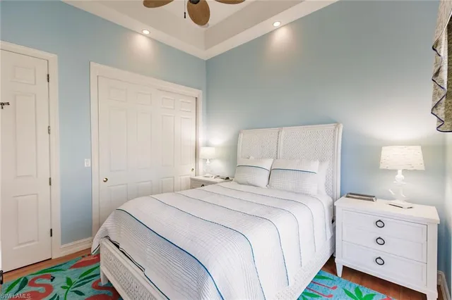 a bedroom with a bed and a lamp on dresser