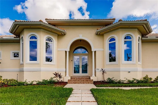 a front view of a house with a garden