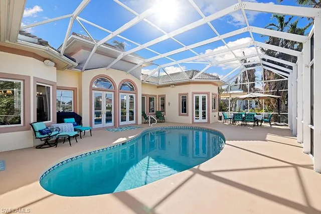 a view of a house with swimming pool and porch