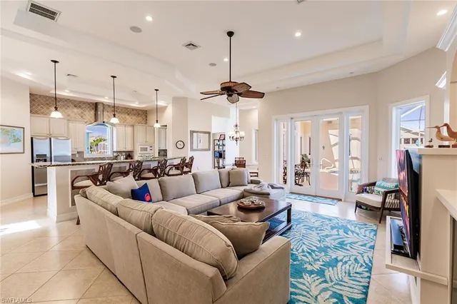 a living room with furniture and a chandelier