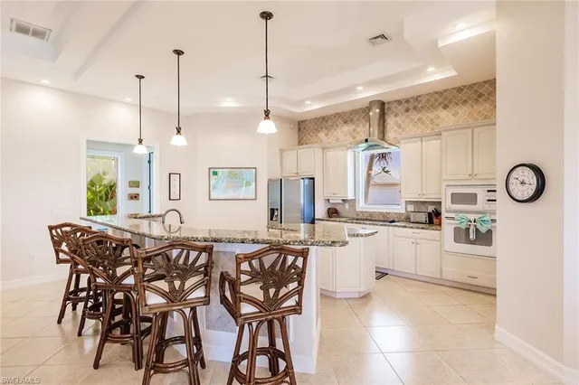 a kitchen with lots of counter space and windows