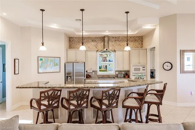 a dining table chairs and a chandelier