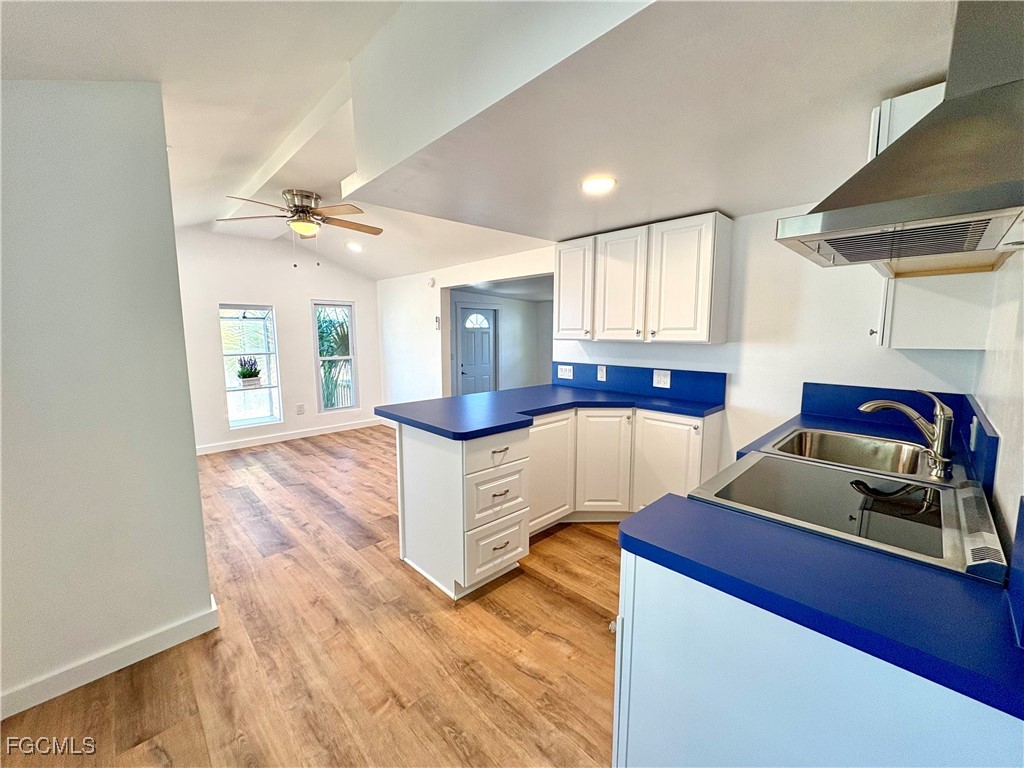 a view of kitchen with sink and wooden floor
