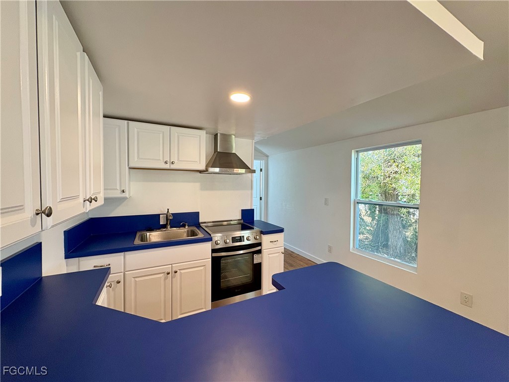 5675 Pine Island Road St. James City, FL 33956 - Photo 13 of 28 a kitchen with stainless steel appliances granite countertop a stove a sink and a microwave