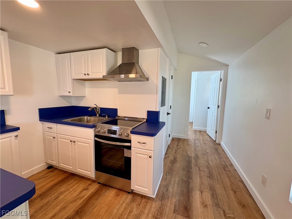5675 Pine Island Road St. James City, FL 33956 - Photo 15 of 28 a kitchen with stainless steel appliances a stove and wooden floor