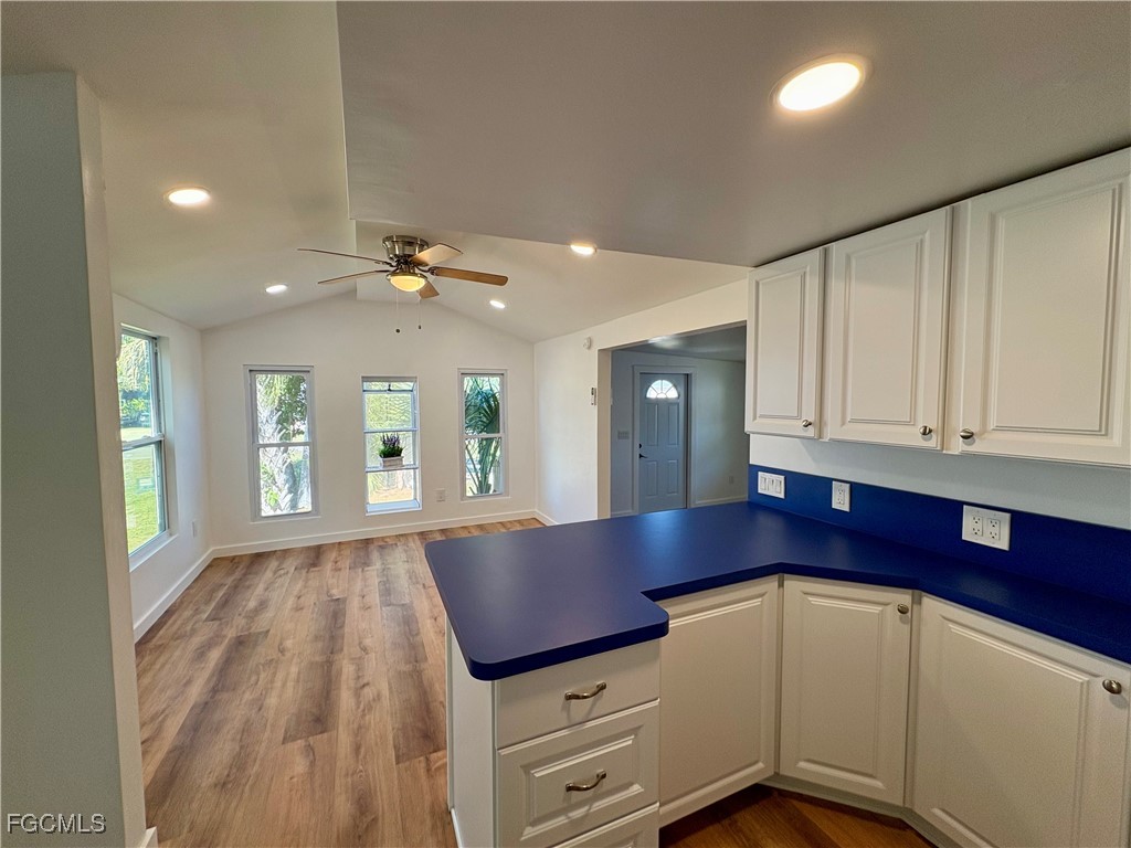 5675 Pine Island Road St. James City, FL 33956 - Photo 16 of 28 a view of kitchen with cabinets and wooden floor