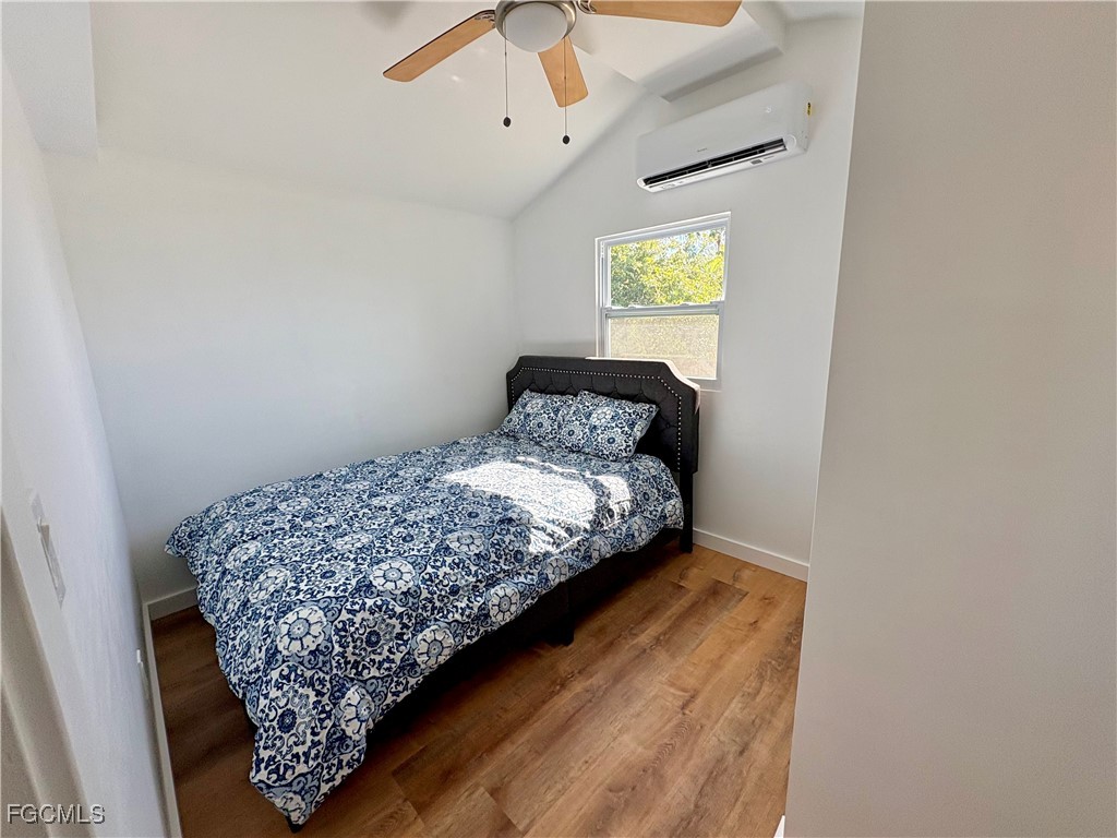 5675 Pine Island Road St. James City, FL 33956 - Photo 19 of 28 a bedroom with a bed and a window