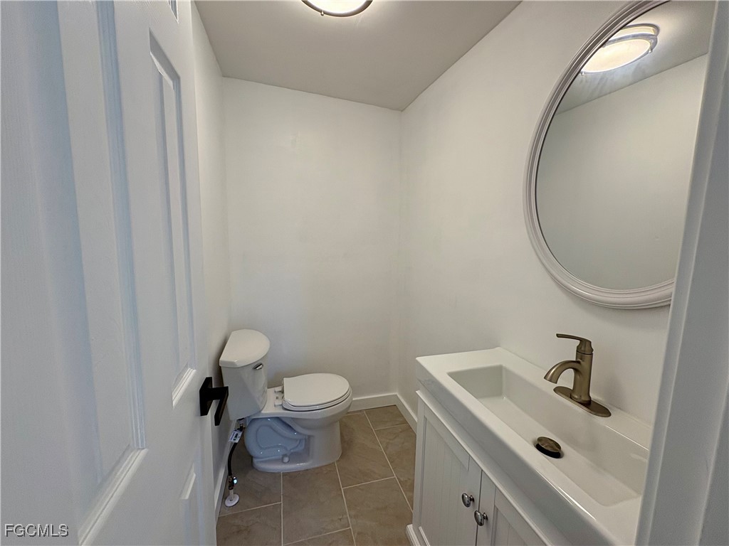 5675 Pine Island Road St. James City, FL 33956 - Photo 23 of 28 a bathroom with a sink and a mirror