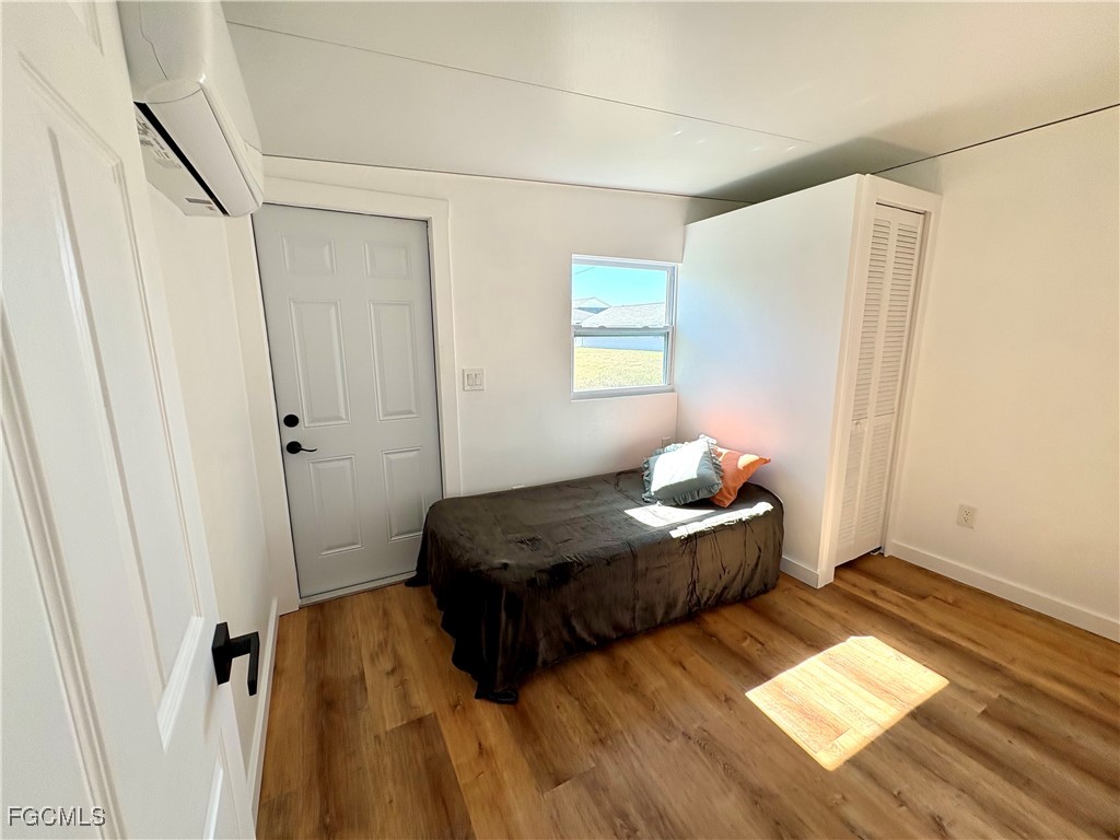 5675 Pine Island Road St. James City, FL 33956 - Photo 24 of 28 a bedroom with bed and window