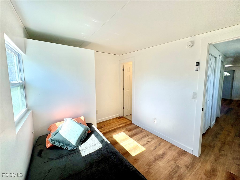 5675 Pine Island Road St. James City, FL 33956 - Photo 25 of 28 a bedroom with a bed and a window