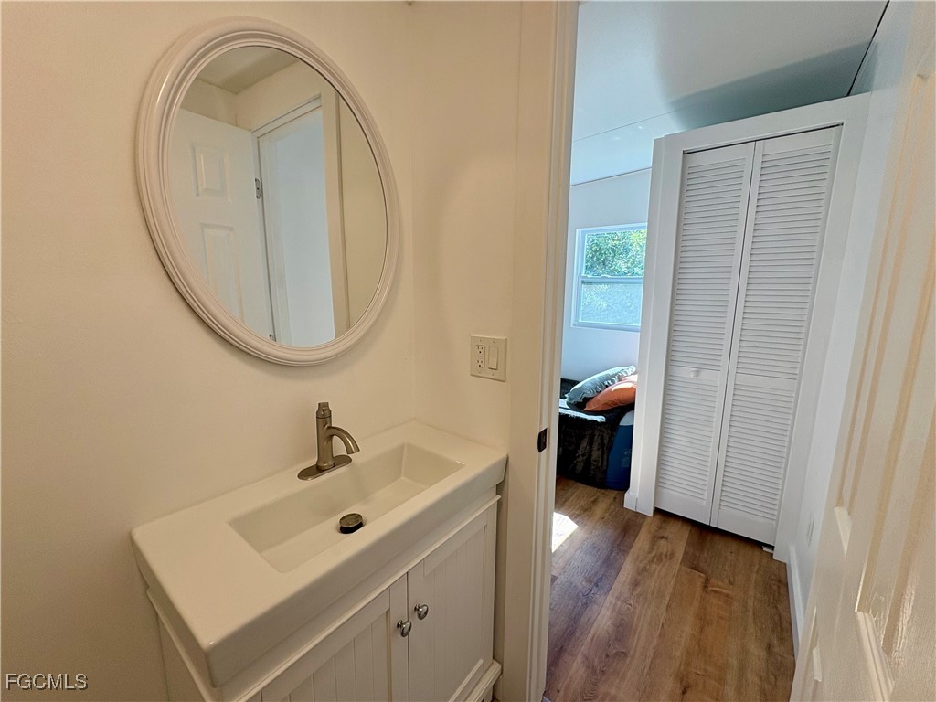 5675 Pine Island Road St. James City, FL 33956 - Photo 27 of 28 a bathroom with a sink and a mirror