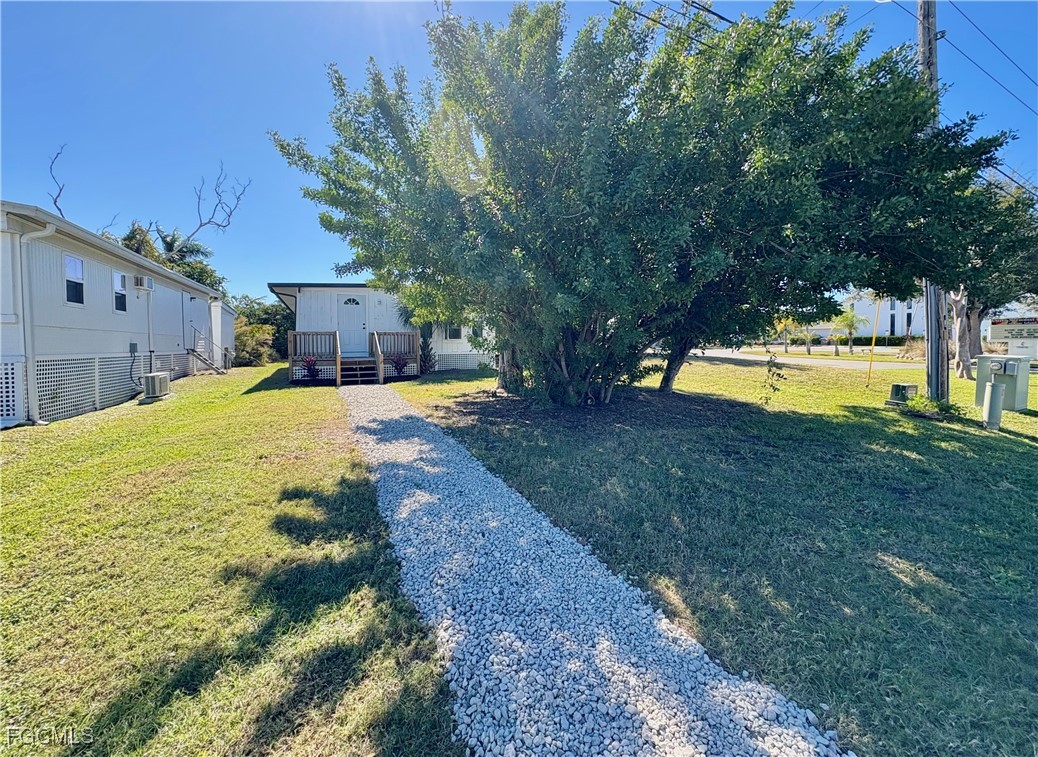 5675 Pine Island Road St. James City, FL 33956 - Photo 4 of 28 a swimming pool with outdoor seating and yard