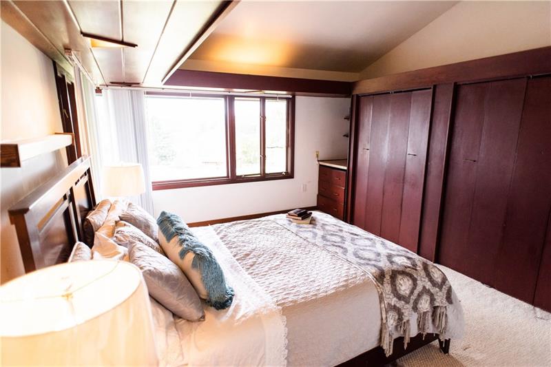151 View Street Indiana, PA 15701 - Photo 7 of 15 Master Bedroom featuring double closets, tall ceilings, and built-in vanity with drawers.