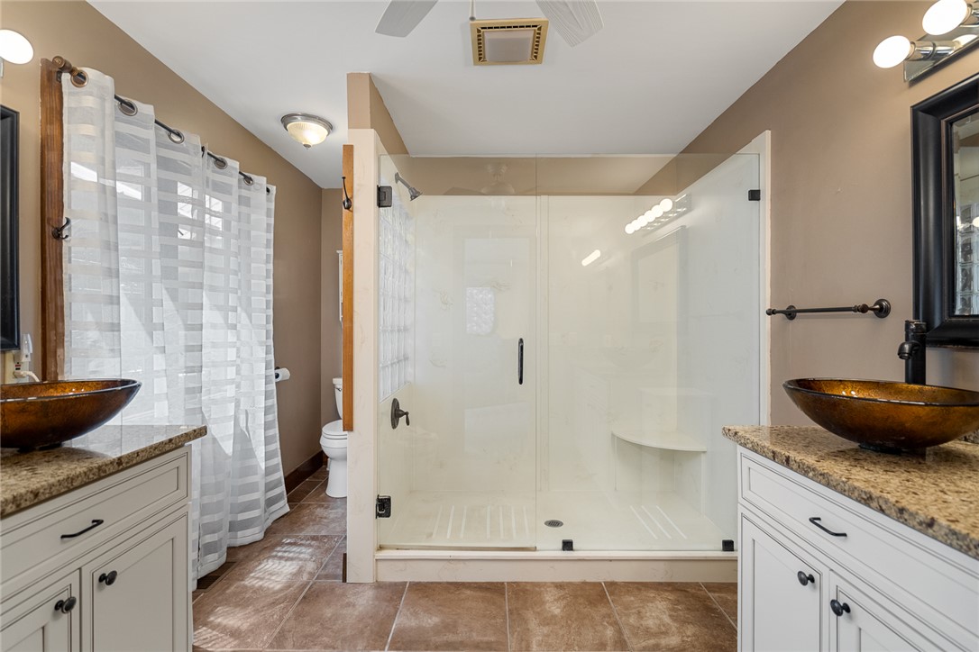 324 Hobson Road Anderson, SC 29621 - Photo 24 of 46 This primary bathroom features a spacious glass-enclosed shower, dual vanities, and durable tile flooring.