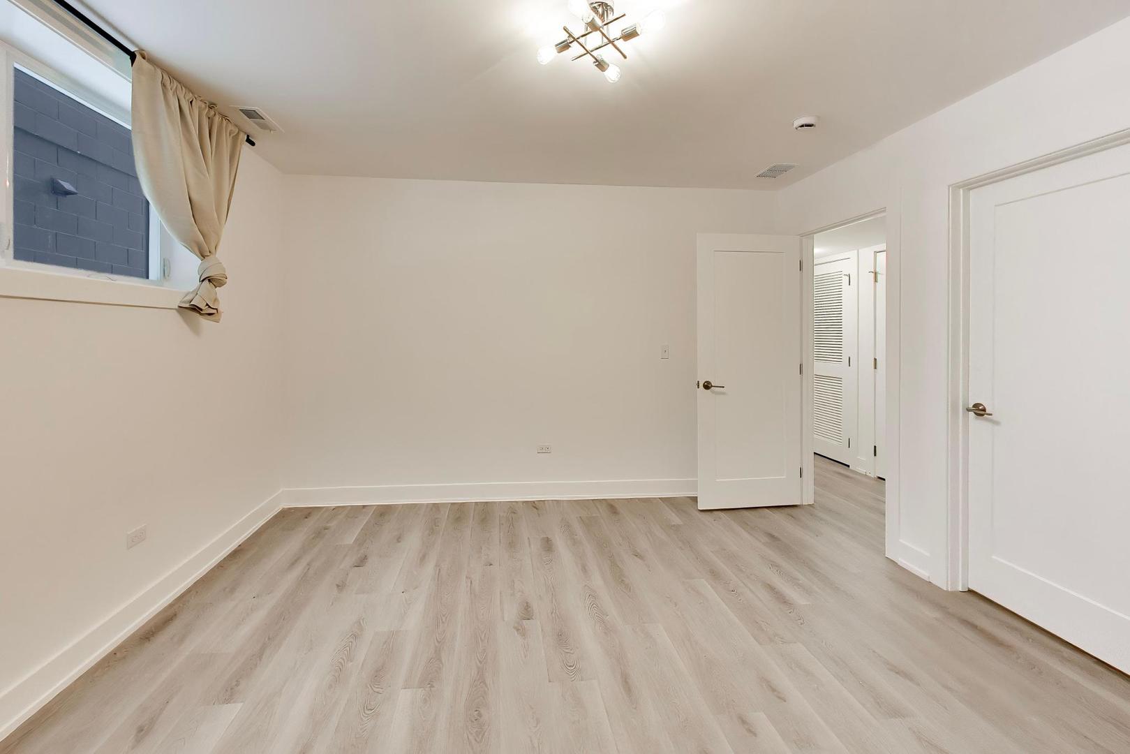 4117 South Indiana Avenue, Unit 1R Chicago, IL 60653 - Photo 21 of 24 wooden floor in an empty room