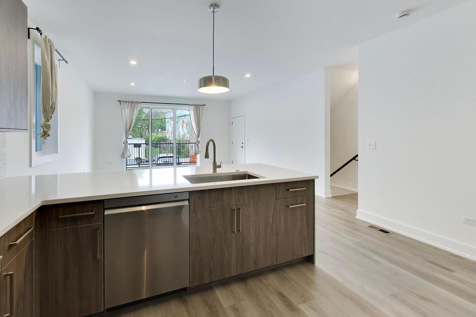 4117 South Indiana Avenue, Unit 1R Chicago, IL 60653 - Photo 10 of 24 a kitchen with a sink and wooden floor
