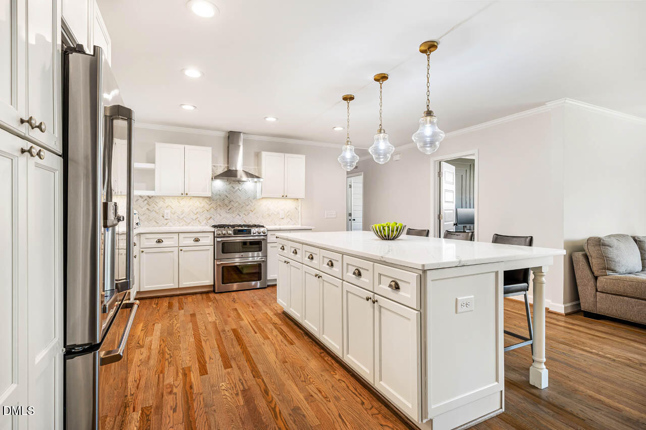 231 Flemington Road Chapel Hill, NC 27517 - Photo 6 of 48 a kitchen with granite countertop a sink appliances cabinets and wooden floor