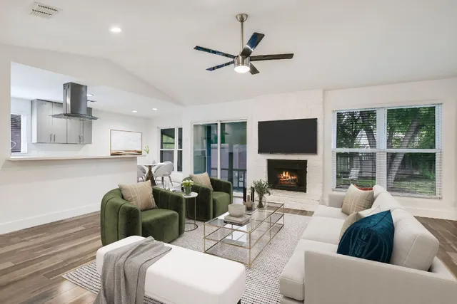 a living room with furniture a window and a fireplace