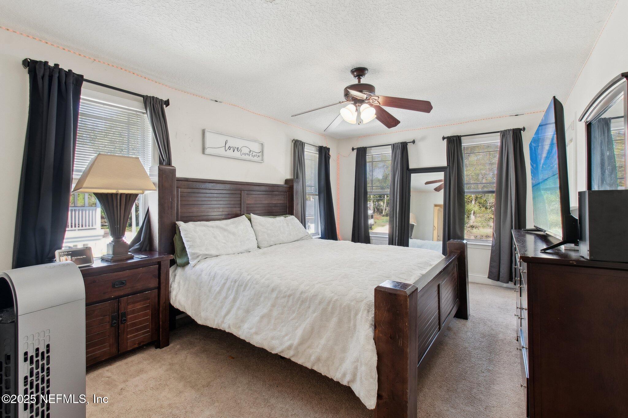 45107 Booth Street Callahan, FL 32011 - Photo 11 of 49 a bed room with a bed and a chandelier