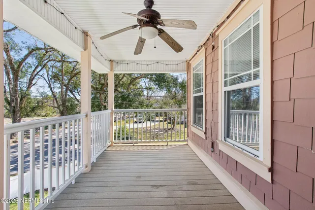 a view of a porch with wooden floor and iron stairs