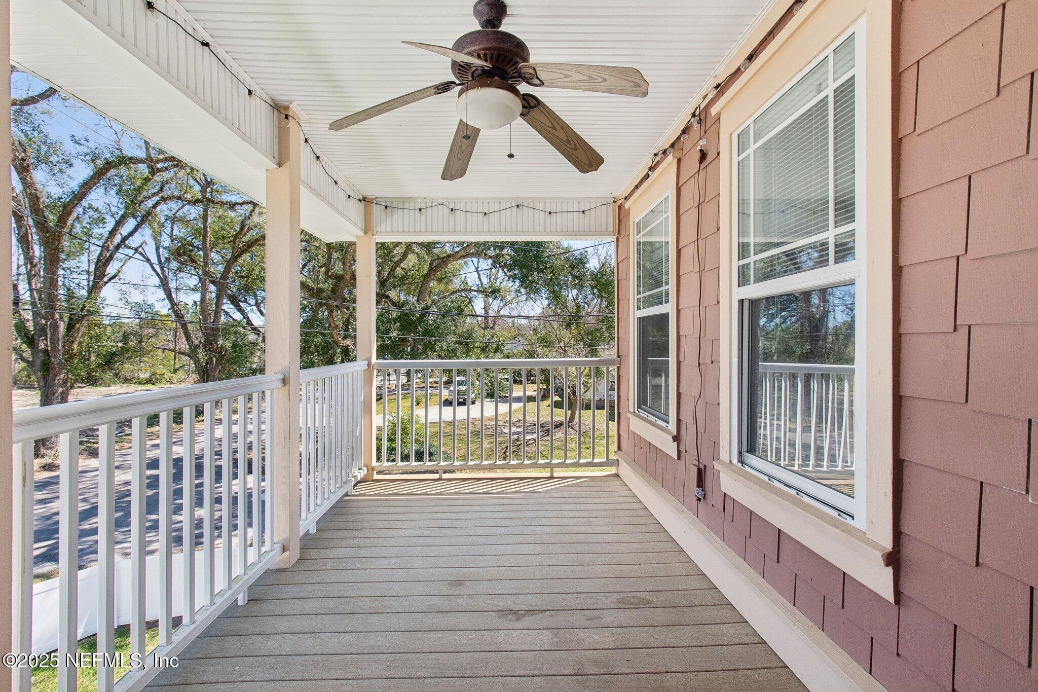 45107 Booth Street Callahan, FL 32011 - Photo 12 of 49 a view of a porch with wooden floor and iron stairs