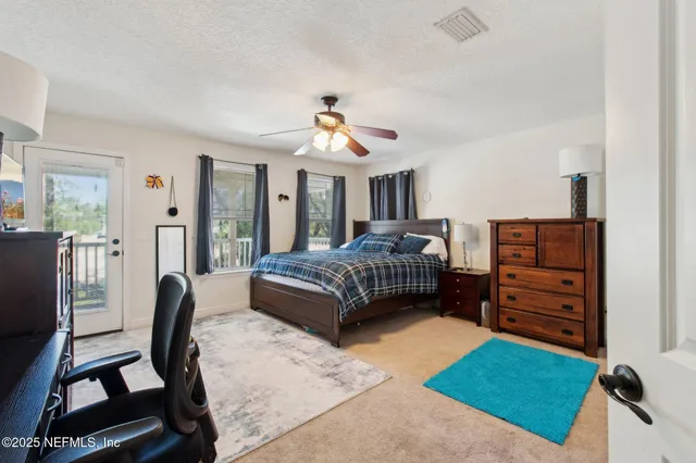 a bedroom with a bed dresser and a chair