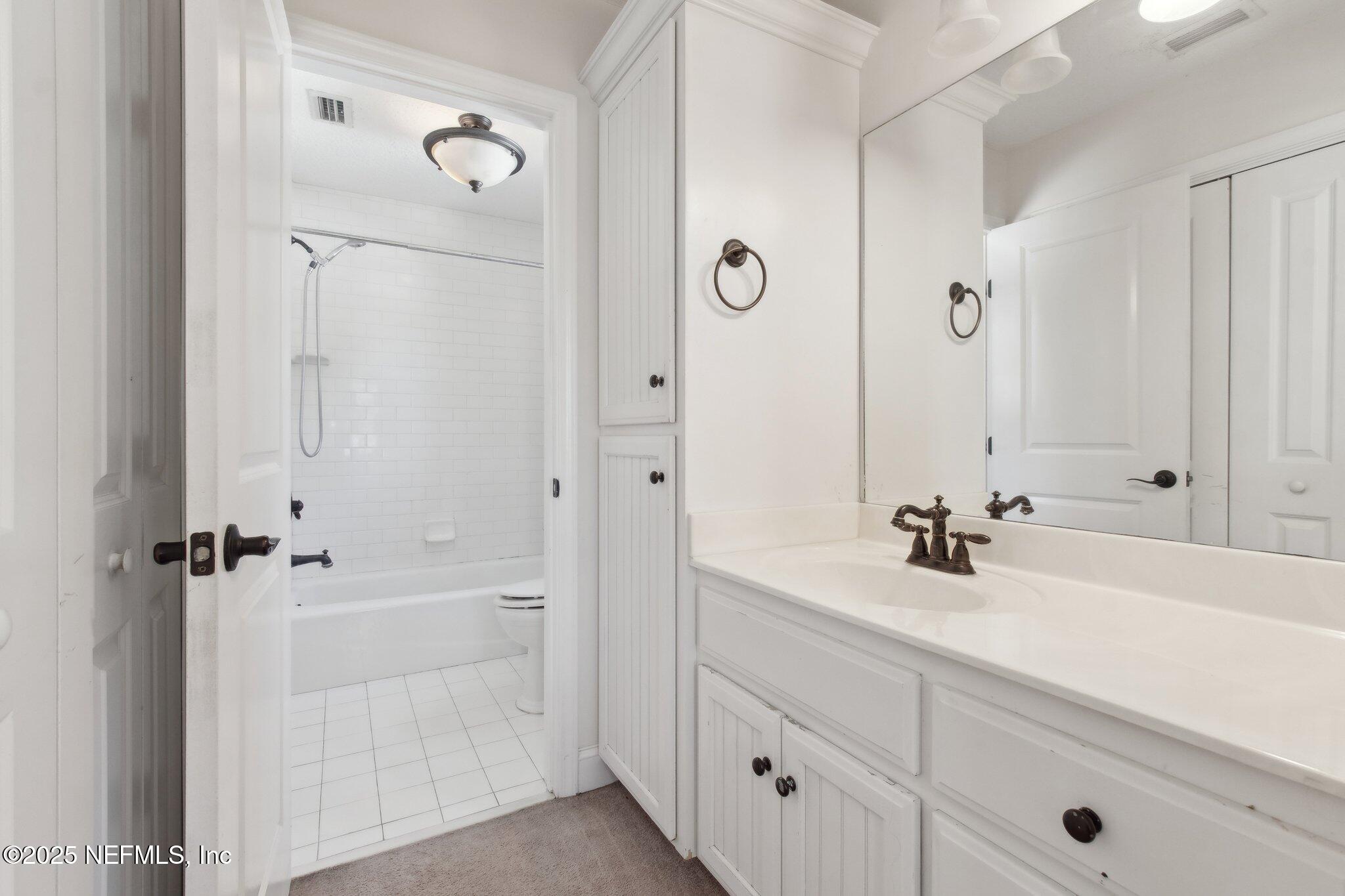 45107 Booth Street Callahan, FL 32011 - Photo 14 of 49 a bathroom with a sink a toilet and shower