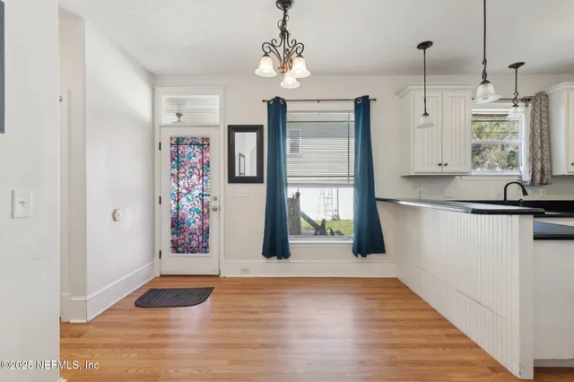 a view of a kitchen with a sink and refrigerator