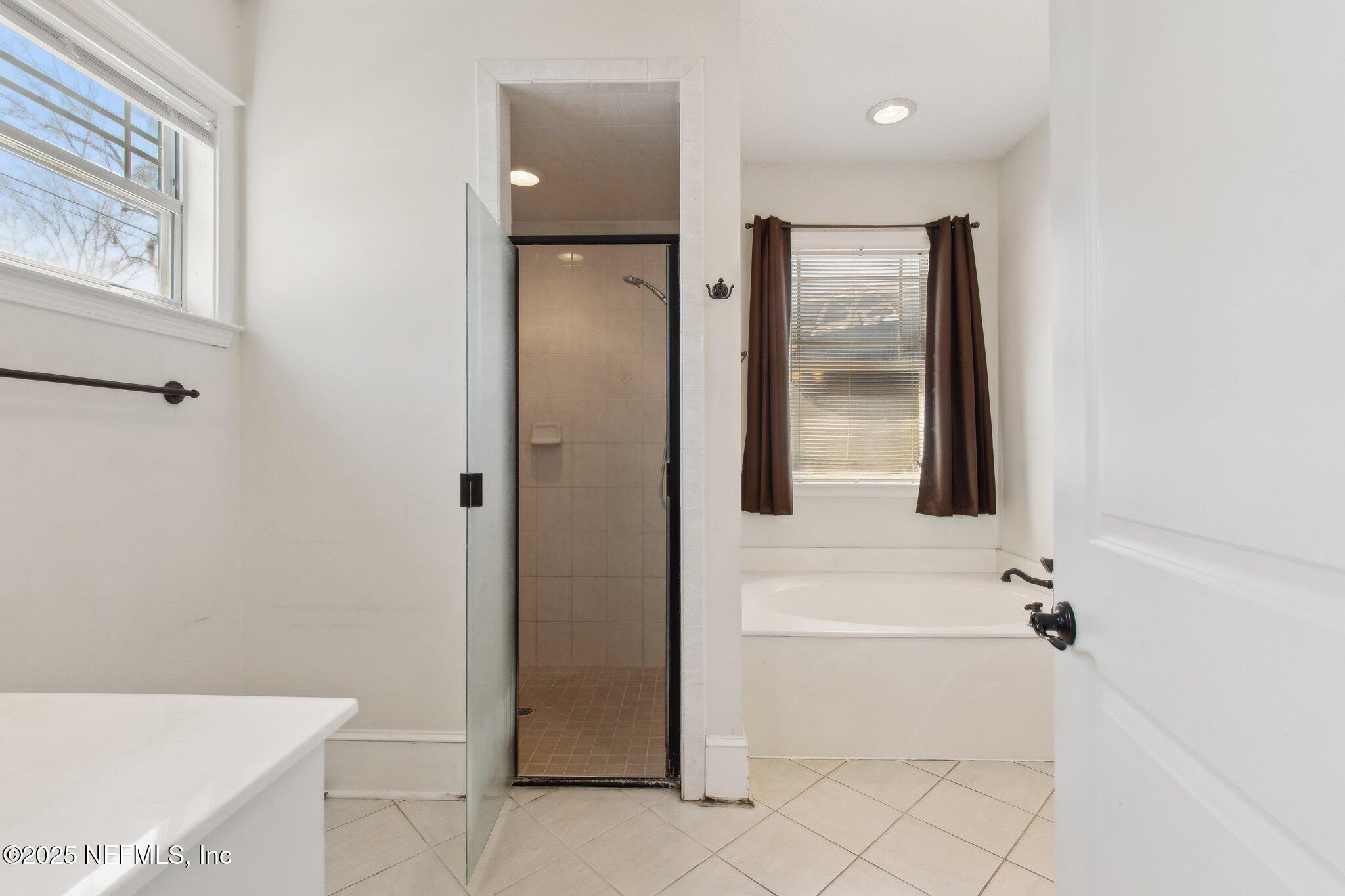 45107 Booth Street Callahan, FL 32011 - Photo 32 of 49 a bathroom with a bathtub and a shower