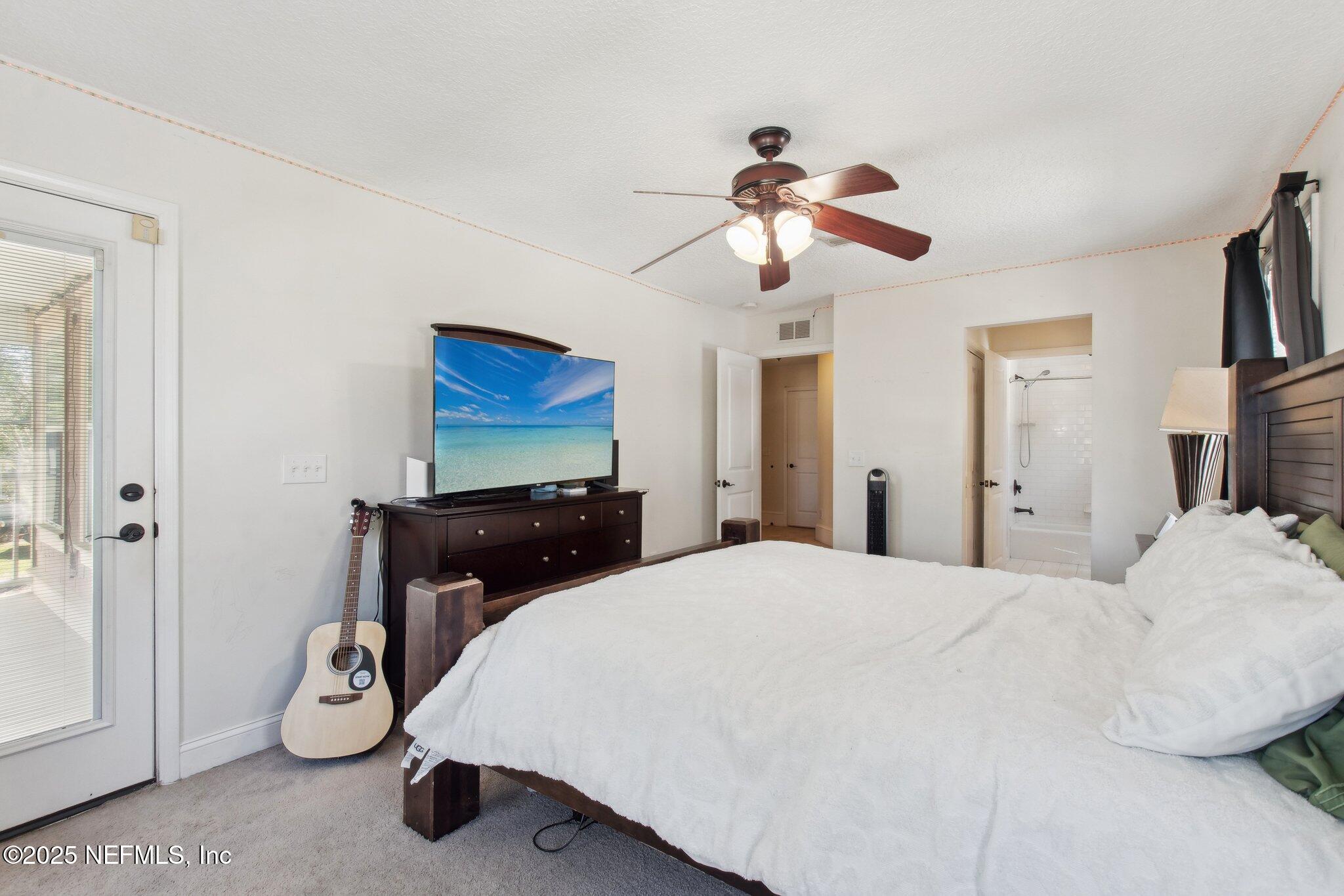45107 Booth Street Callahan, FL 32011 - Photo 34 of 49 a bedroom with a bed and a chandelier