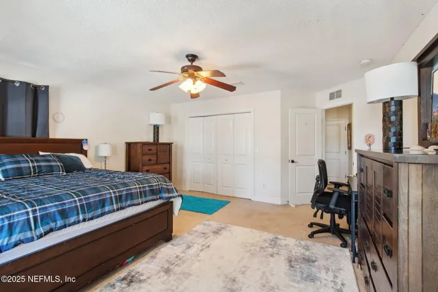 a bedroom with a bed and dresser