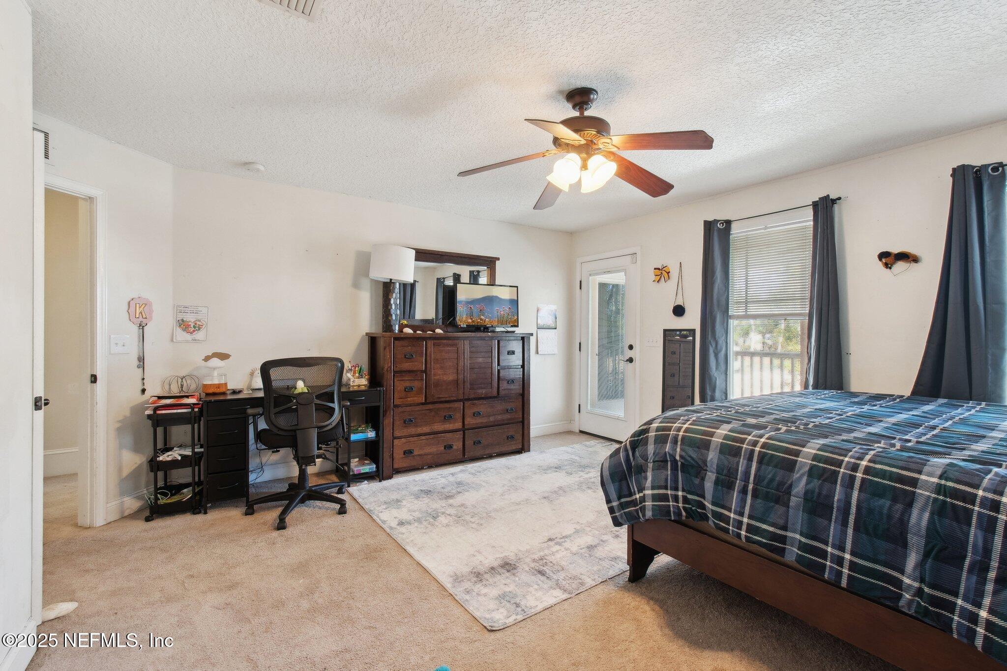 45107 Booth Street Callahan, FL 32011 - Photo 38 of 49 a bedroom with a bed and dresser