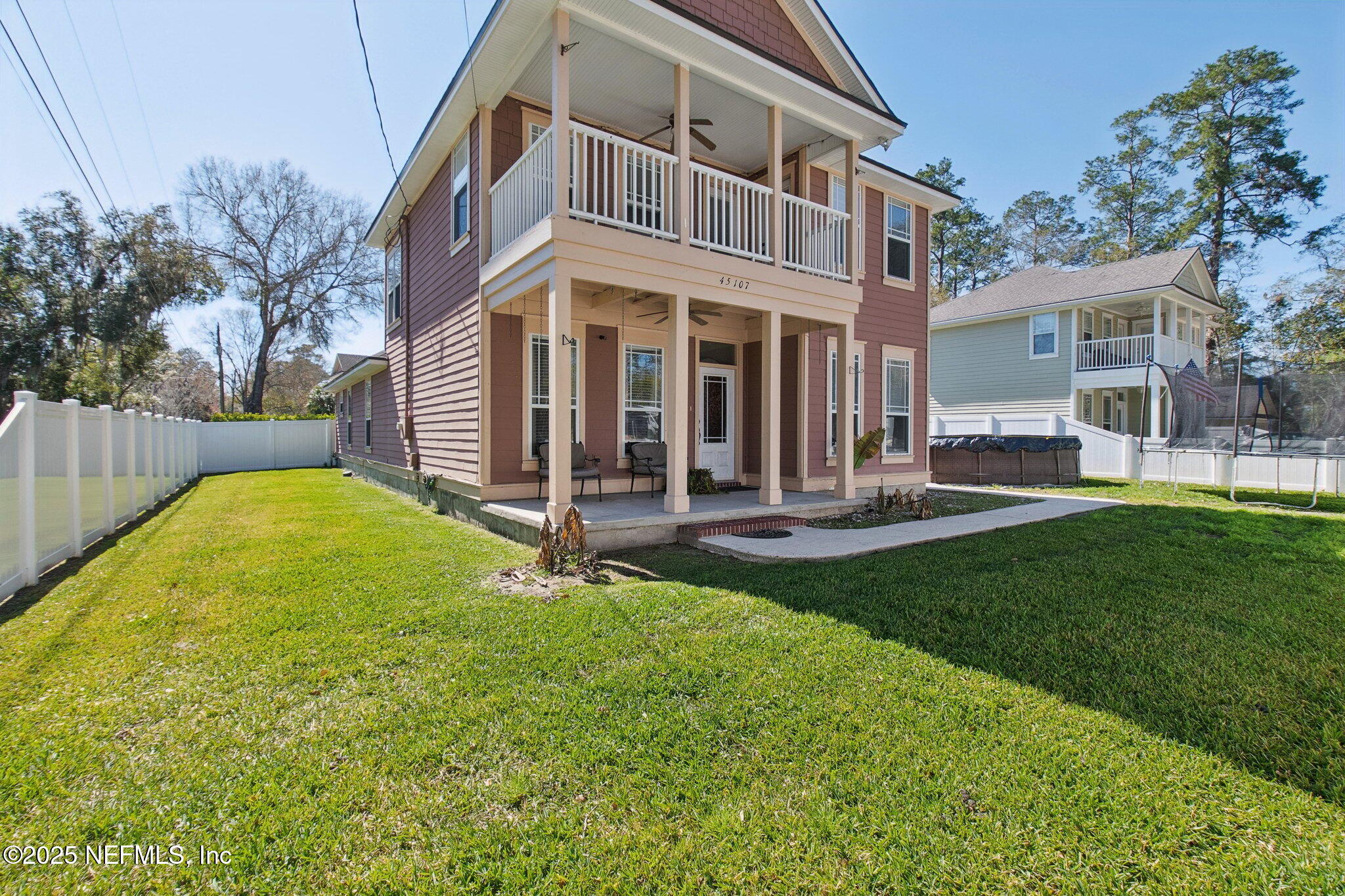 45107 Booth Street Callahan, FL 32011 - Photo 40 of 49 a front view of a house with a yard table and chairs