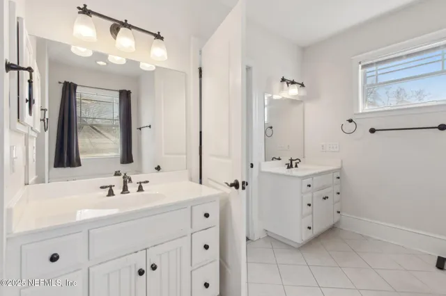 a bathroom with a double vanity sink mirror and double