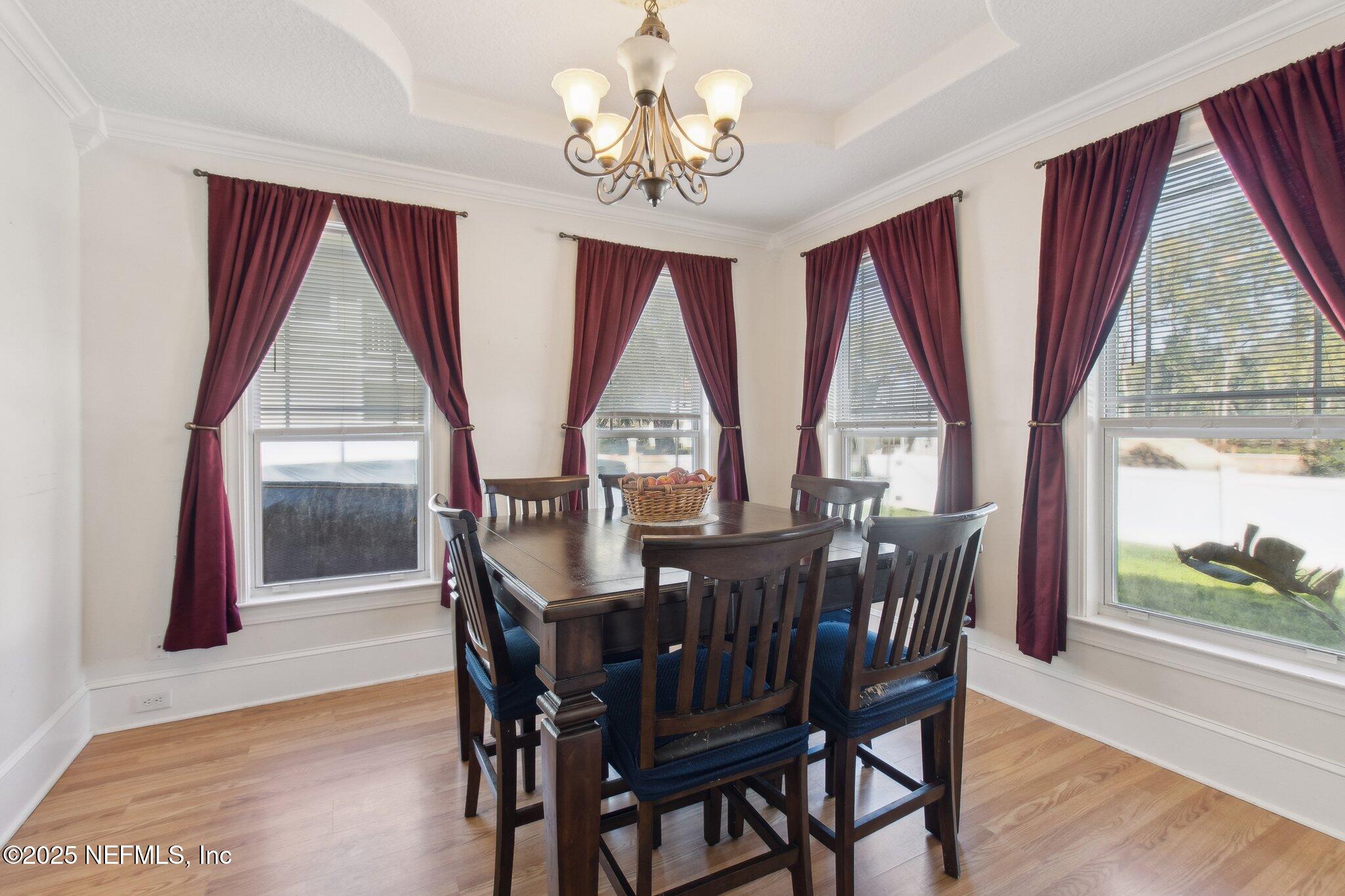 45107 Booth Street Callahan, FL 32011 - Photo 10 of 49 a view of a dining room with furniture wooden floor and chandelier