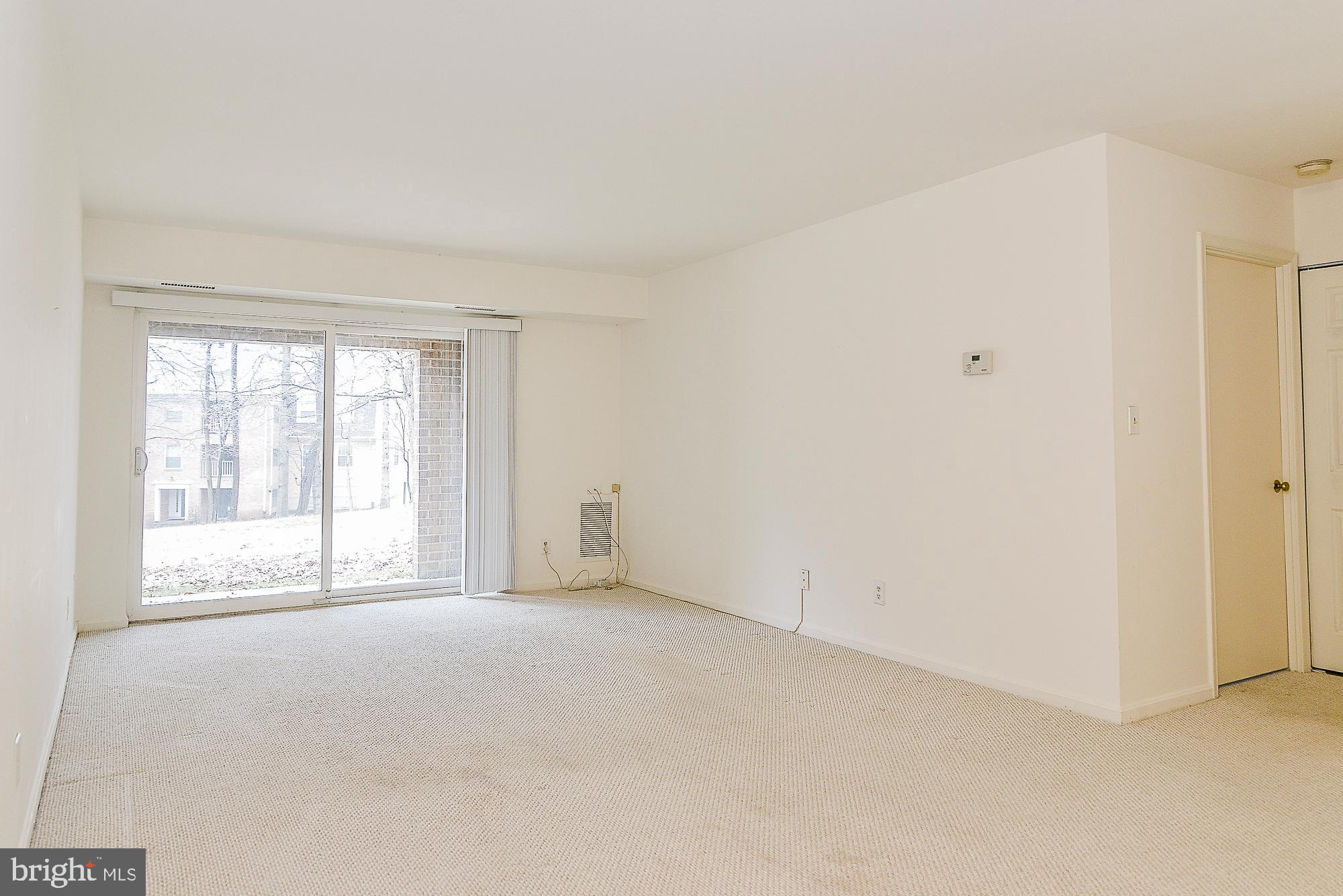 5938 Cove Landing Road, Unit 102A Burke, VA 22015 - Photo 4 of 19 Light-filled living room access to private patio!