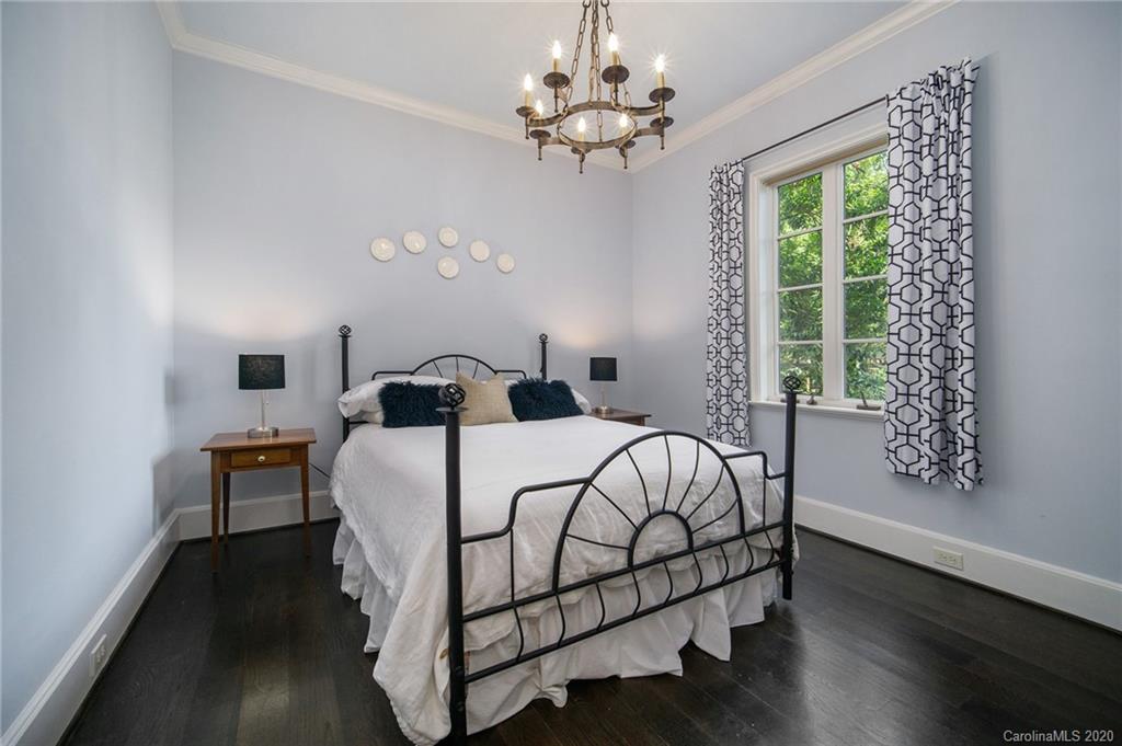 1500 Andover Road Charlotte, NC 28211 - Photo 11 of 24 a bedroom with a large bed and a chandelier