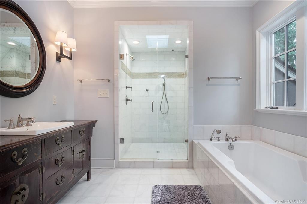 1500 Andover Road Charlotte, NC 28211 - Photo 17 of 24 a bathroom with a bathtub a mirror a vanity and a shower